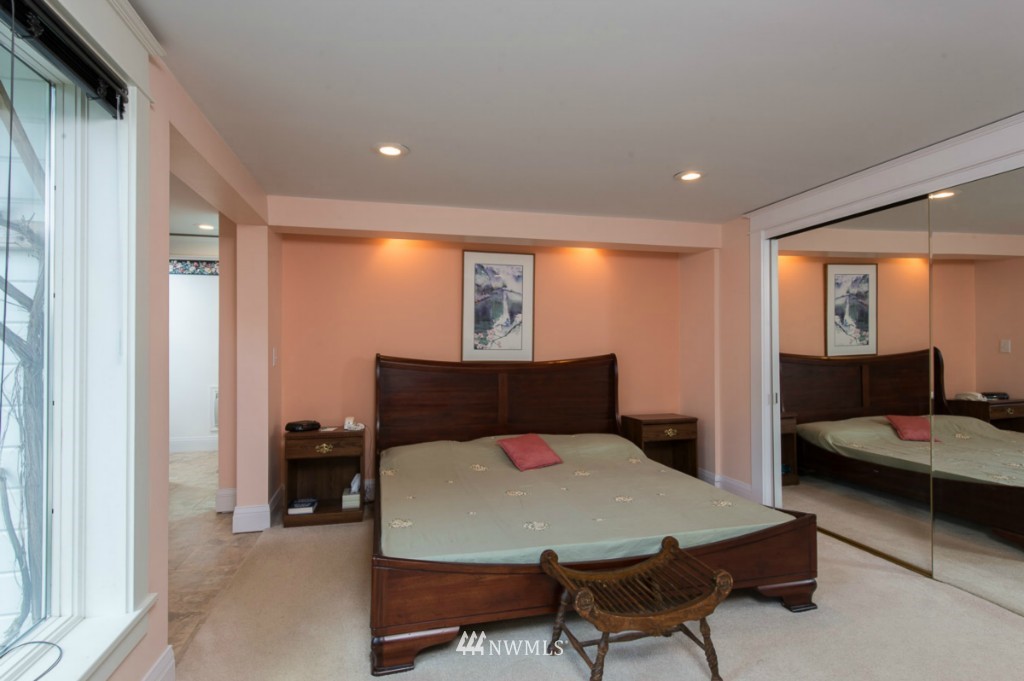 18624 Beall Road Southwest Vashon, WA 98070 - Photo 13 of 25 a bed room with a bed and a chair