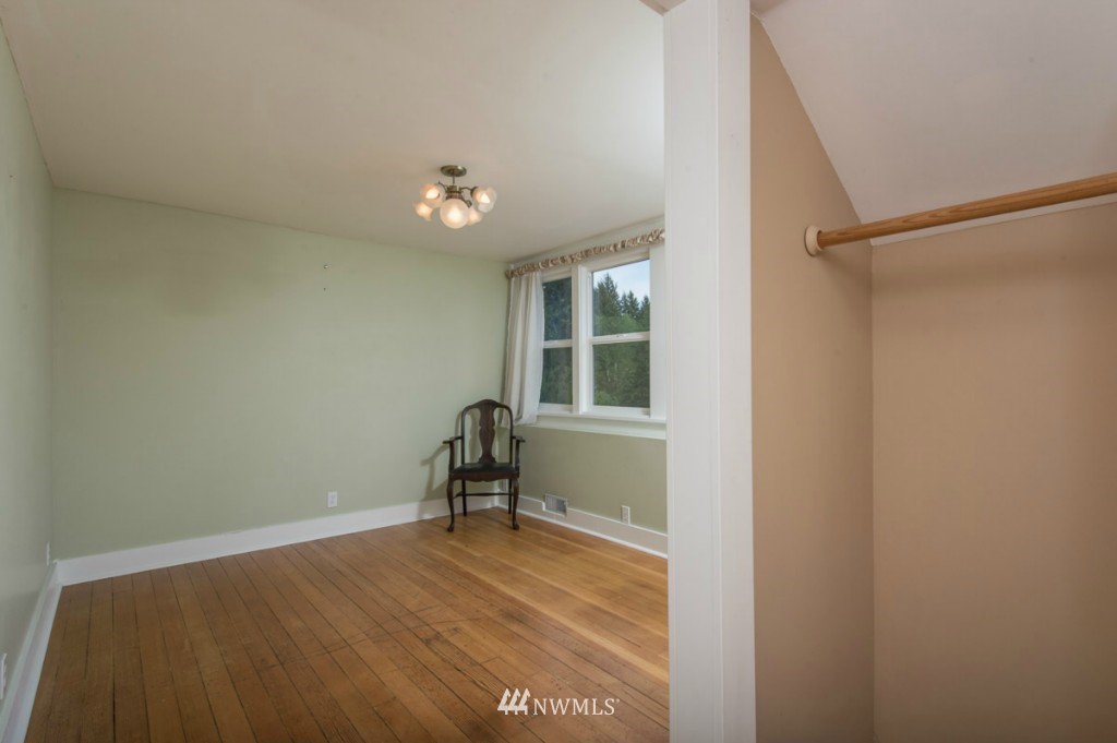 18624 Beall Road Southwest Vashon, WA 98070 - Photo 17 of 25 a view of room with a ceiling fan and wooden floor