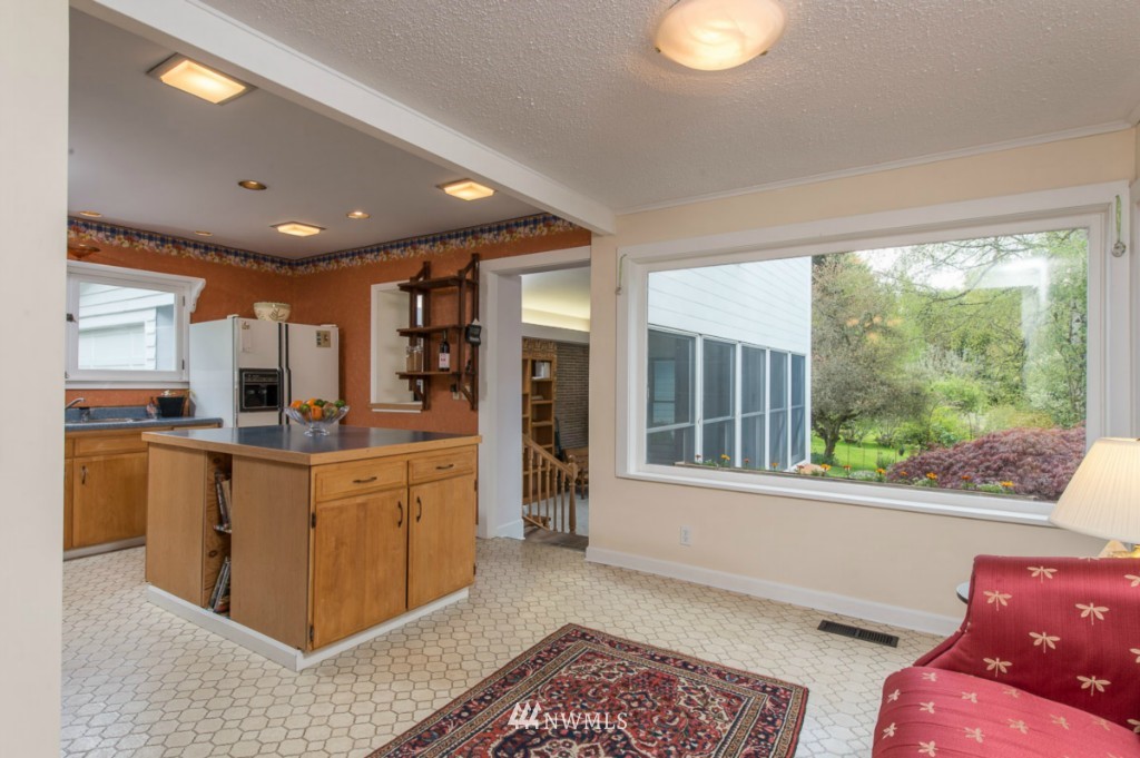 18624 Beall Road Southwest Vashon, WA 98070 - Photo 10 of 25 a open kitchen with stainless steel appliances granite countertop a refrigerator a sink dishwasher a stove and a large window