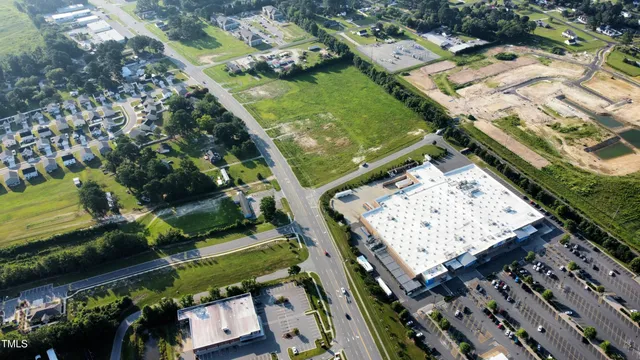 an aerial view of a residential houses with outdoor space and swimming pool