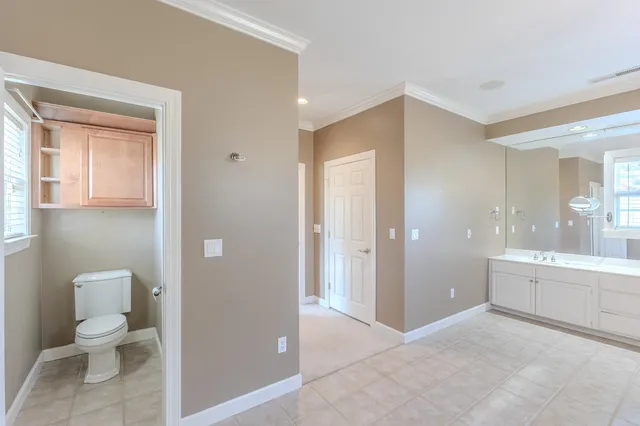 a bathroom with a toilet sink and a mirror