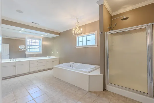 a bathroom with a bathtub a sink and a window