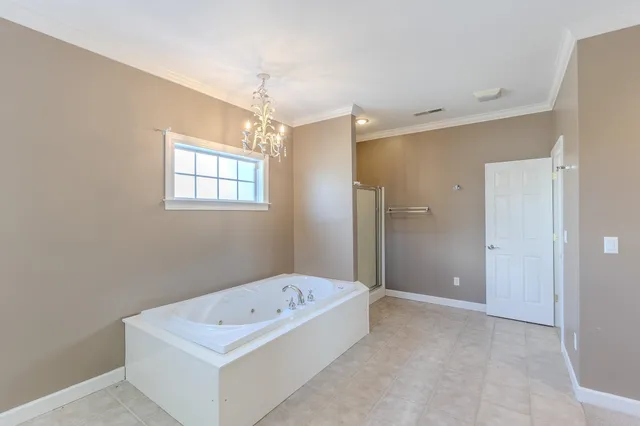 a bathroom with a tub shower and a sink