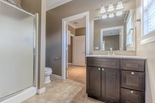 a bathroom with a sink a toilet and a mirror