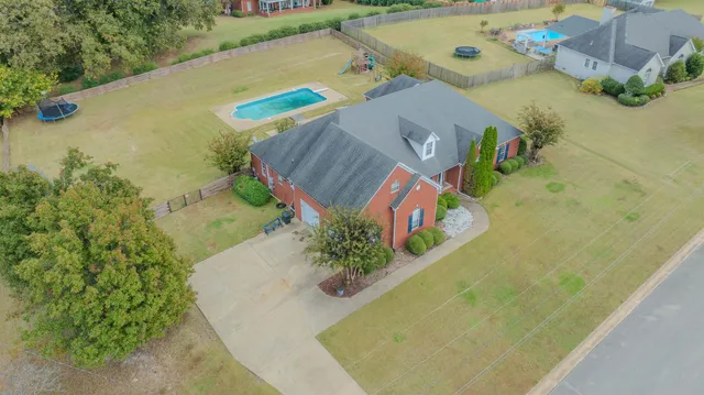 an aerial view of a house with a swimming pool