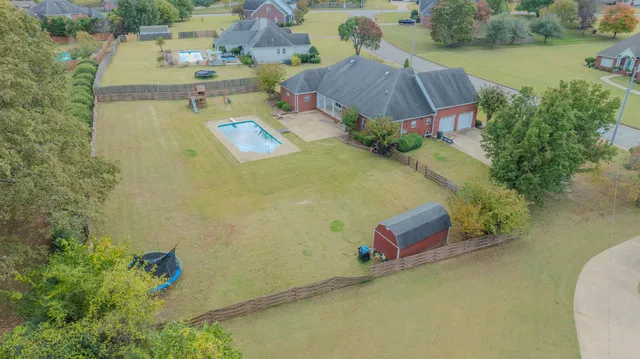an aerial view of a house with outdoor space and lake view