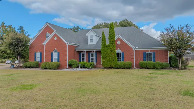 a front view of house with yard and green space