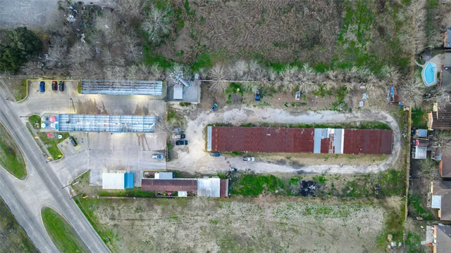 an aerial view of residential houses with outdoor space and lakeside