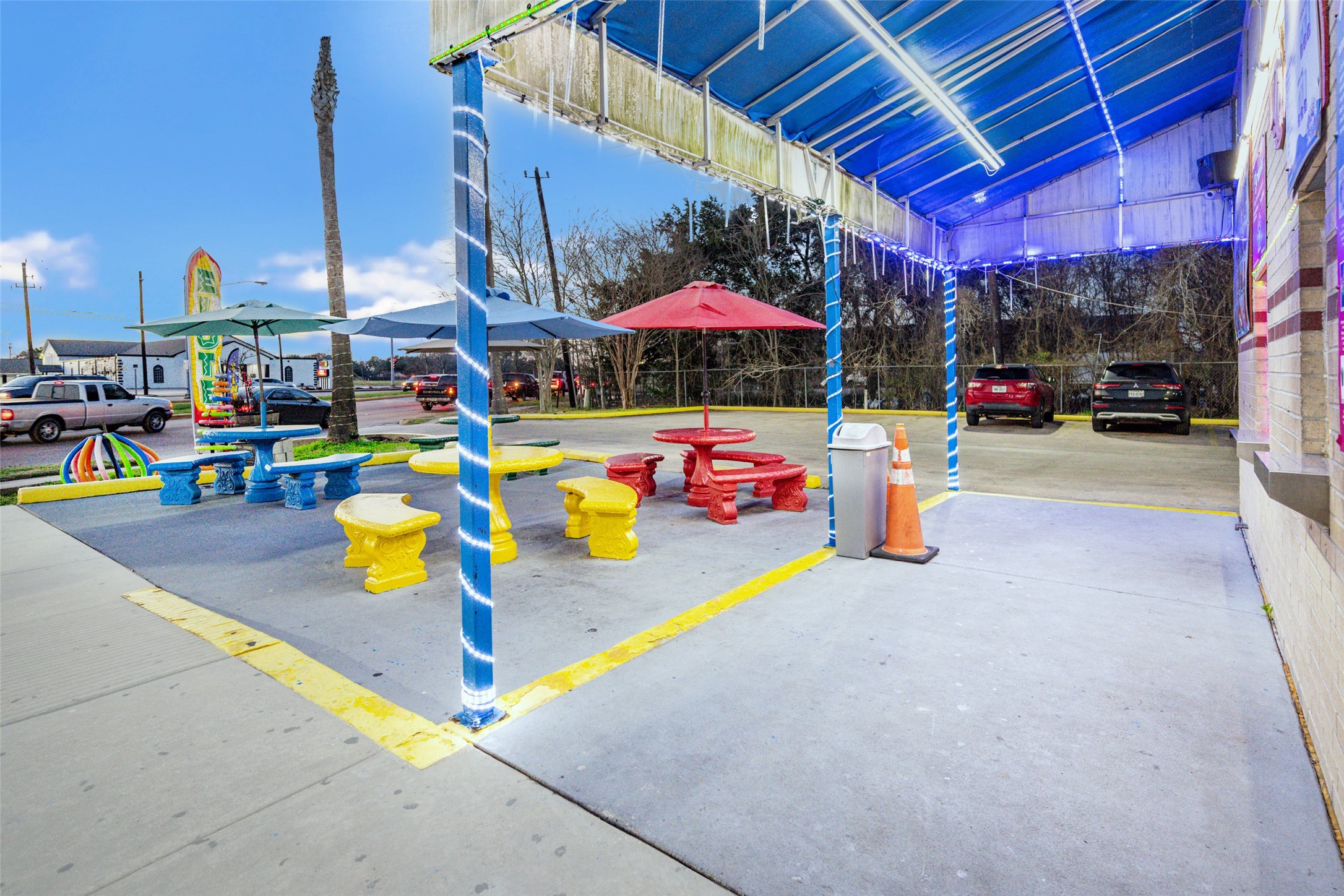 2627 Allen Genoa Road Pasadena, TX 77502 - Photo 5 of 37 a view of garage with a table and chairs under an umbrella