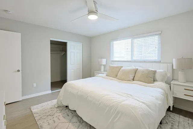a bedroom with a large bed and a large window