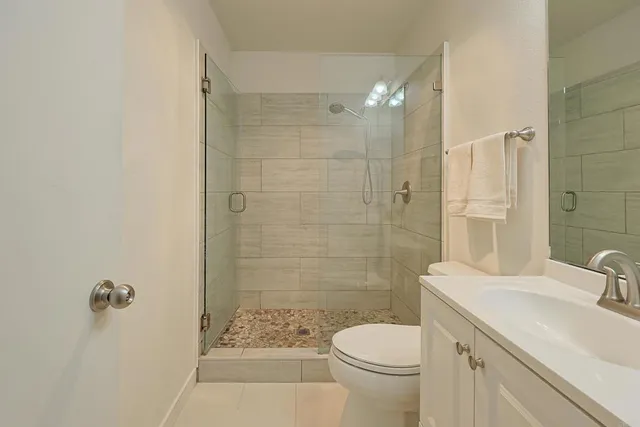 a patio with a table and chairs under an umbrella