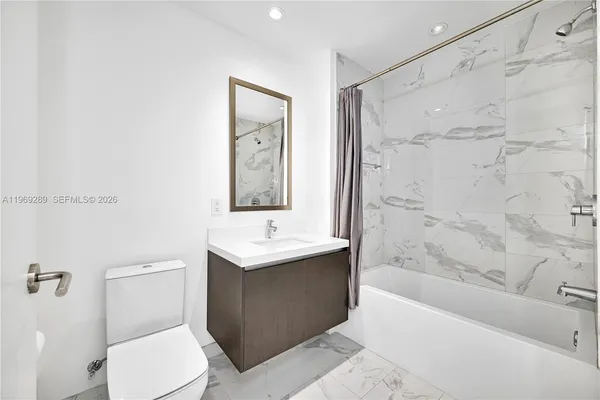 a bathroom with a toilet a sink and bathtub