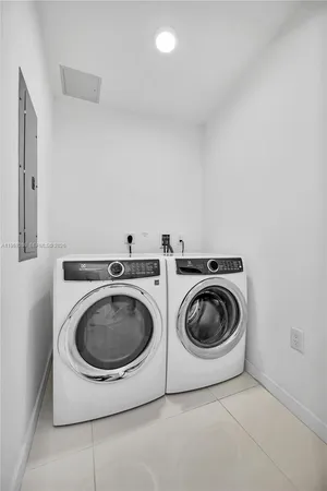a utility room with sink dryer and washer