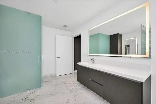 a bathroom with a double vanity sink and a mirror