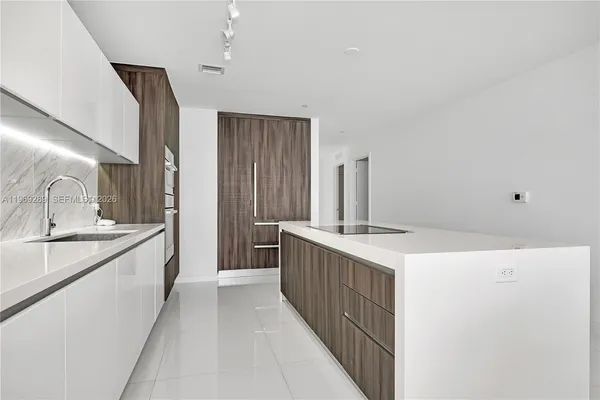 a kitchen with a sink stove and cabinets