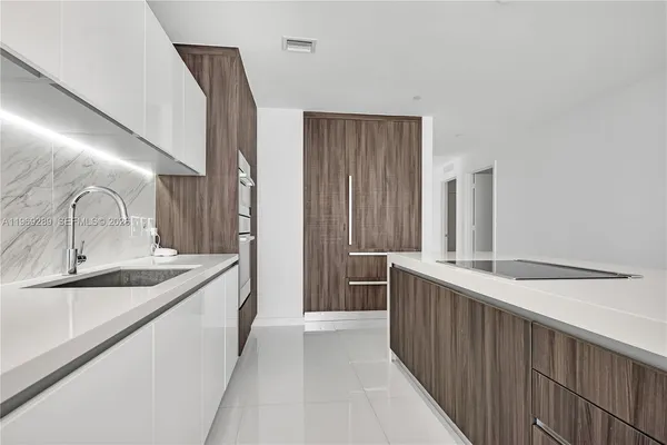 a kitchen with a sink and refrigerator