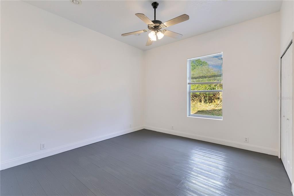 704 Grape Avenue St. Cloud, FL 34769 - Photo 11 of 30 an empty room with a window and a fan