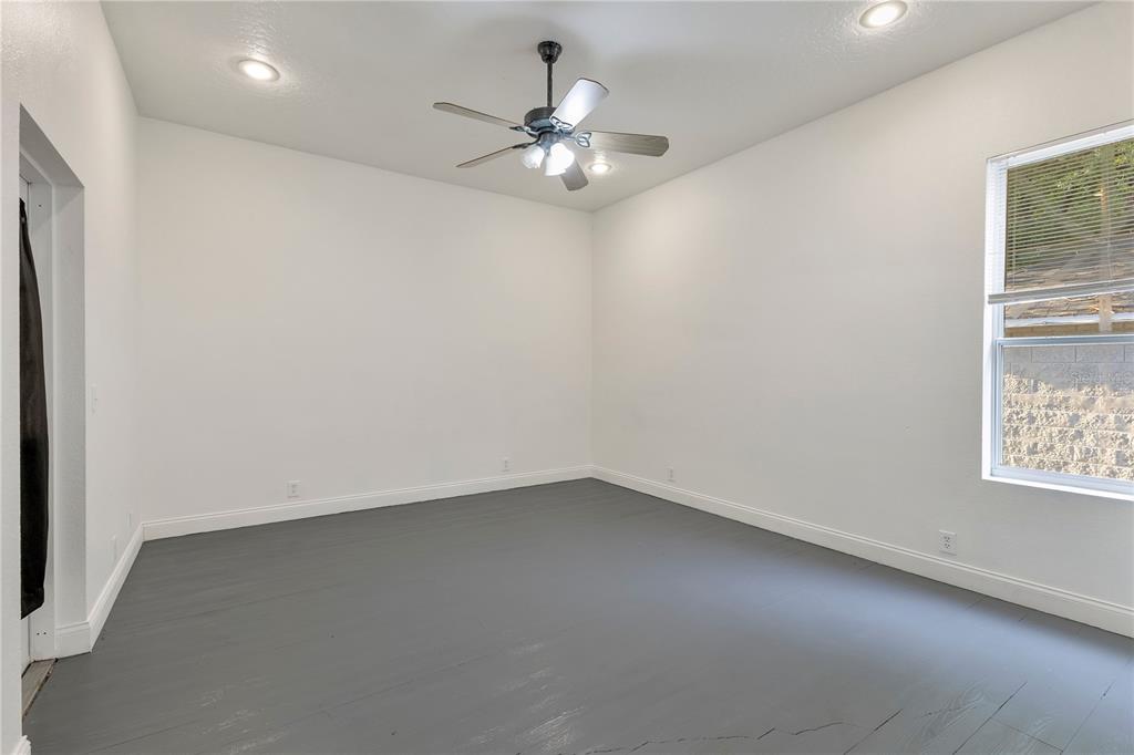704 Grape Avenue St. Cloud, FL 34769 - Photo 12 of 30 an empty room with chandelier fan and windows