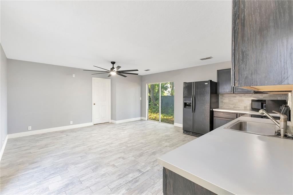 704 Grape Avenue St. Cloud, FL 34769 - Photo 17 of 30 a view of a kitchen stove a sink and dishwasher with wooden floor