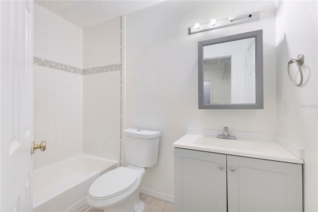 704 Grape Avenue St. Cloud, FL 34769 - Photo 19 of 30 a white toilet sitting next to a bathroom sink