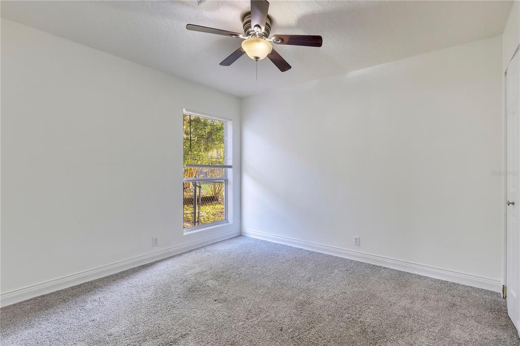 704 Grape Avenue St. Cloud, FL 34769 - Photo 20 of 30 an empty room with windows and chandelier fan