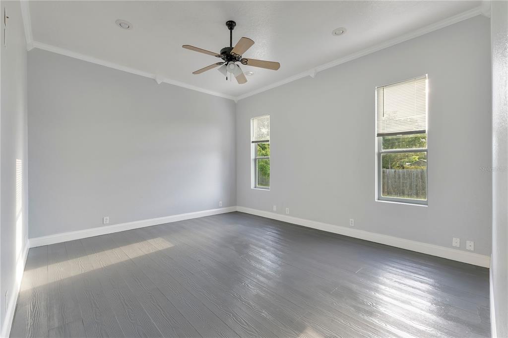 704 Grape Avenue St. Cloud, FL 34769 - Photo 7 of 30 wooden floor in an empty room with a window
