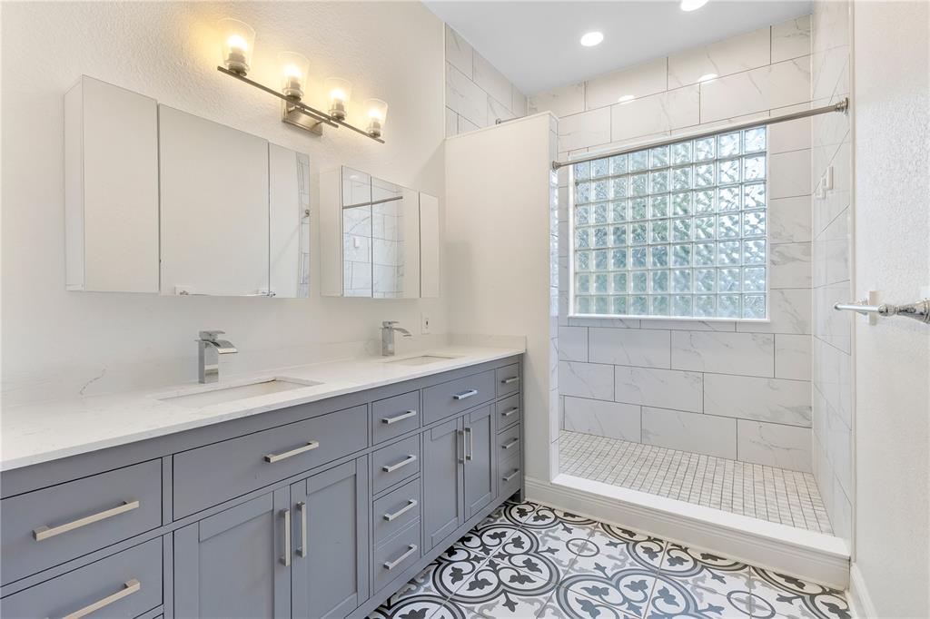 704 Grape Avenue St. Cloud, FL 34769 - Photo 8 of 30 a bathroom with a shower sink and mirror