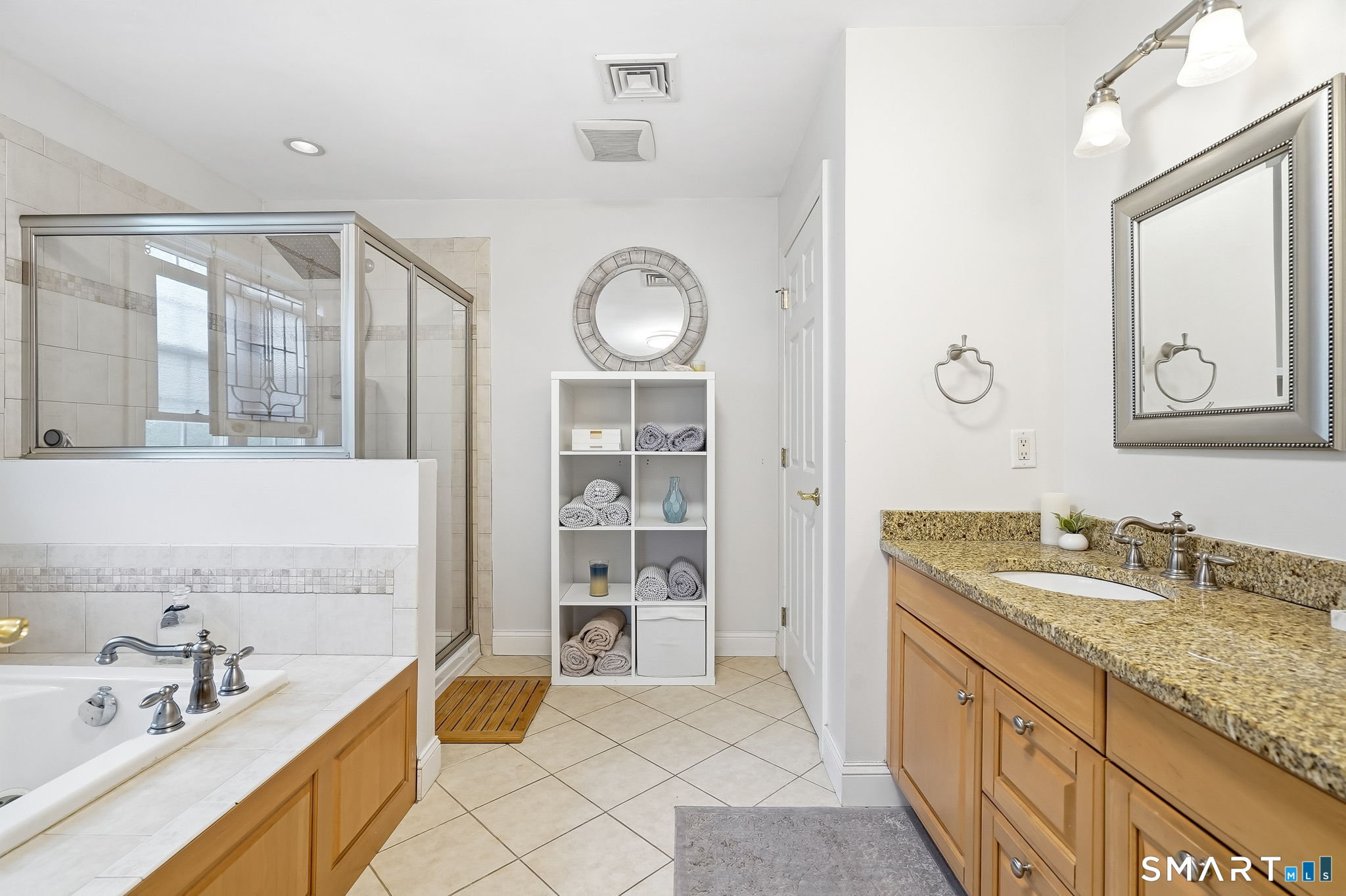 80 3rd Avenue Stratford, CT 06615 - Photo 26 of 40 a spacious bathroom with a granite countertop tub sink and mirror