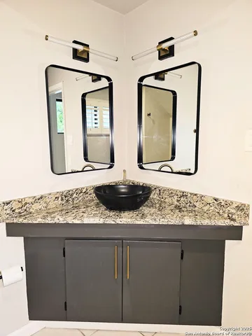 a bathroom with mirror and window