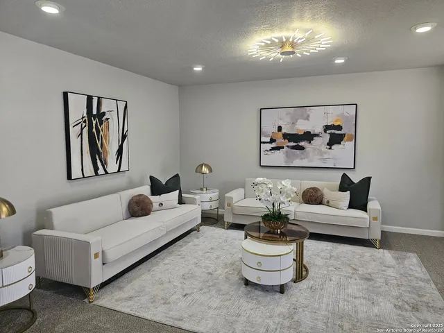 a living room with furniture and a painting