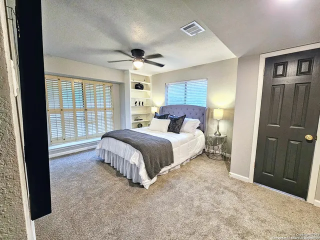 a bedroom with a large bed and a large window