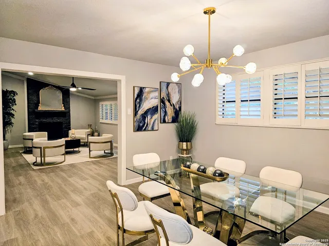 a view of a dining room with furniture and a chandelier