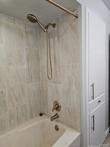 a bathroom with a tub and a shower