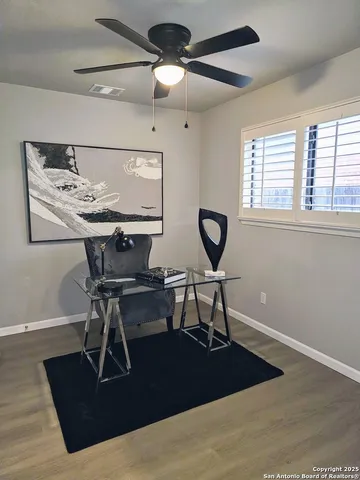a view of a workspace with furniture and a window