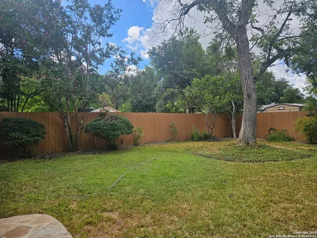 a backyard of a house with lots of green space