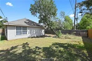 a front view of a house with a garden and yard