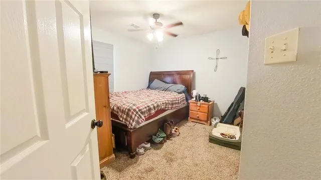 a bedroom with bed and a window