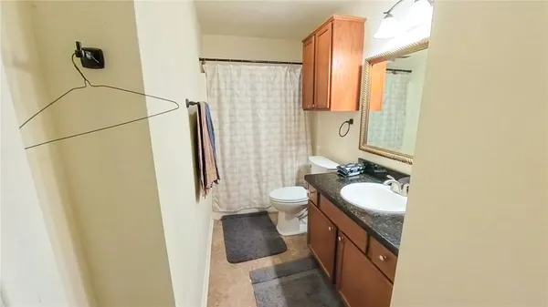 a bathroom with a double vanity sink toilet and shower