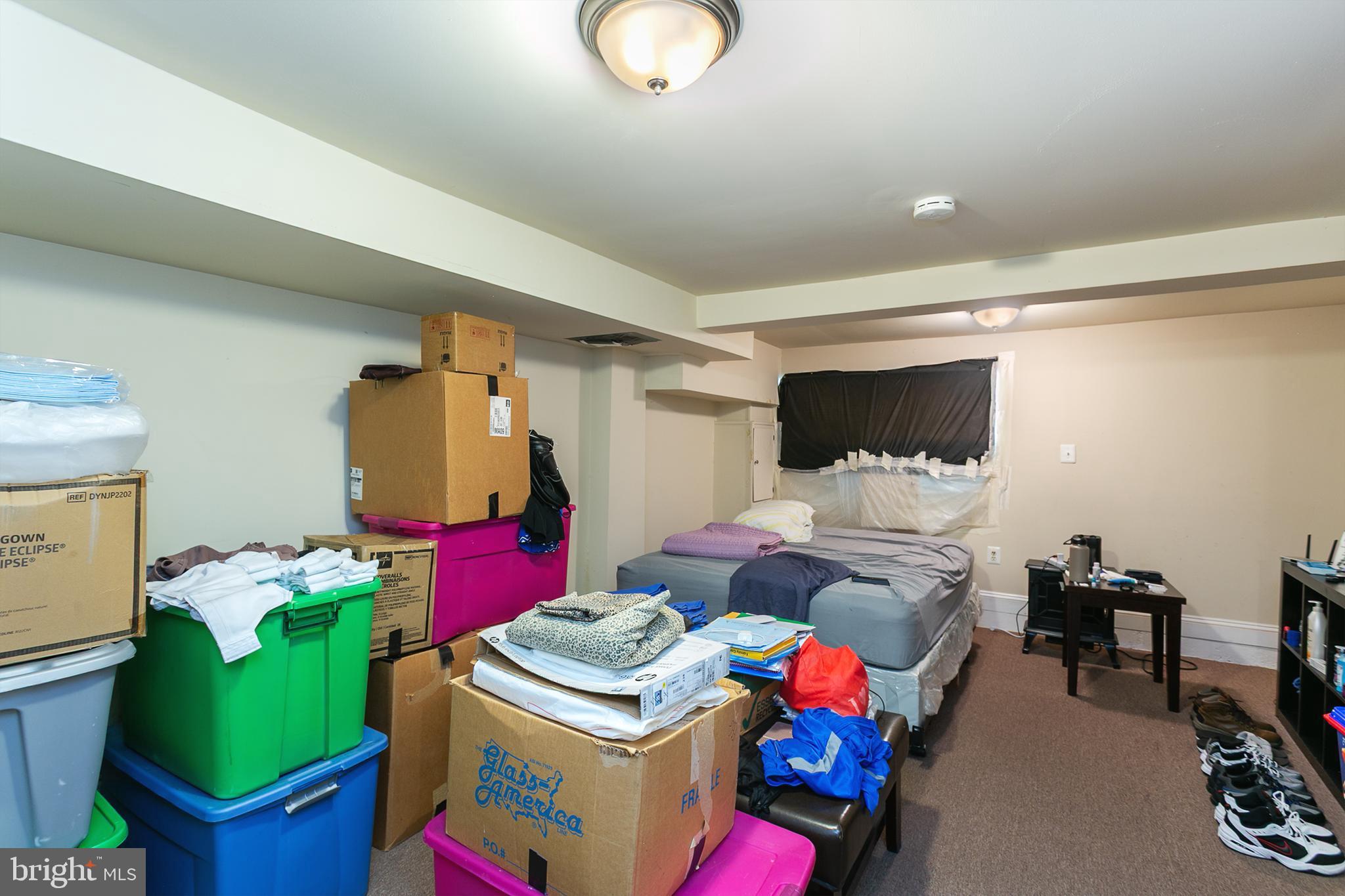 2736 East Preston Street Baltimore, MD 21213 - Photo 11 of 15 a living room filled with furniture and a bed