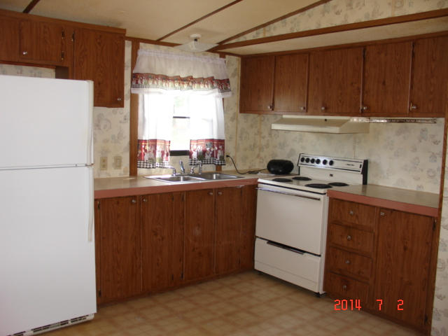 104 Ramblin Rose Road Vinton, VA 24179 - Photo 4 of 14 a kitchen with a refrigerator sink and cabinets
