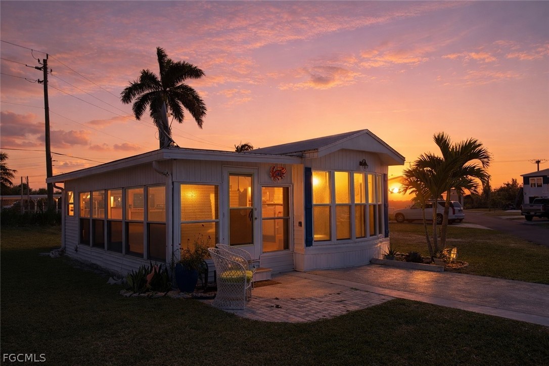 19681 Summerlin Road, Unit 482 Fort Myers, FL 33908 - Photo 1 of 35 a front view of a house with a garden