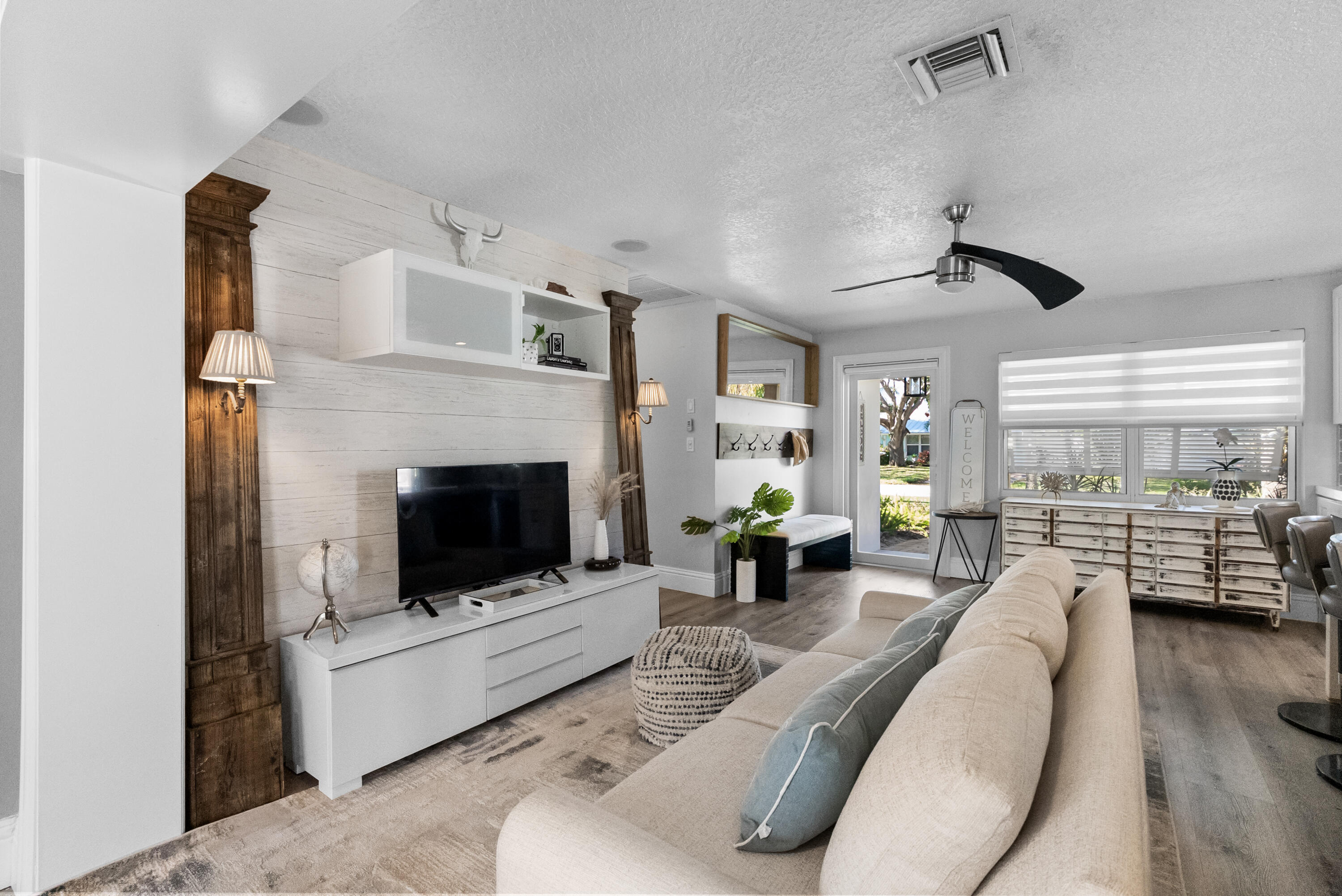 1605 Treemont Avenue Jupiter, FL 33469 - Photo 15 of 35 a living room with furniture and a fireplace