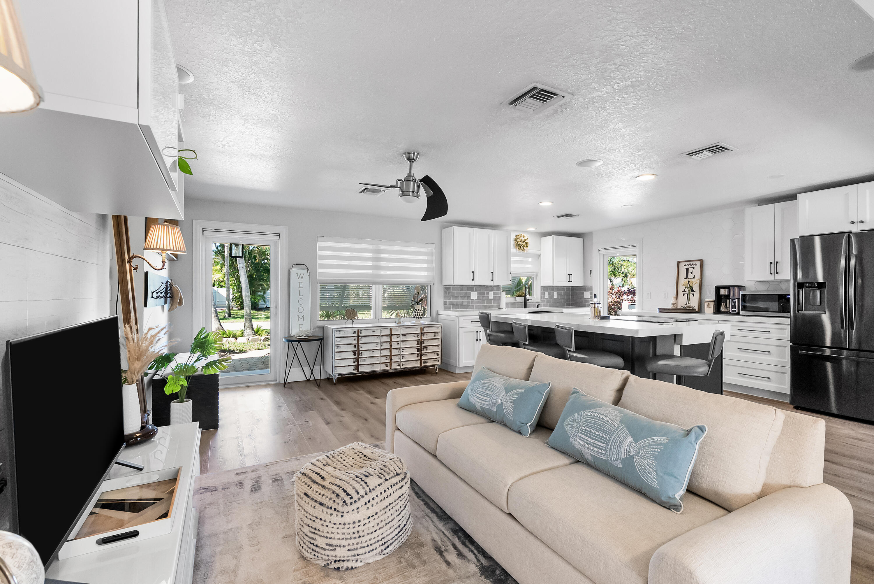 1605 Treemont Avenue Jupiter, FL 33469 - Photo 16 of 35 a living room with furniture and a flat screen tv