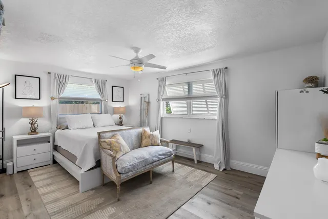 a bedroom with a bed and a chandelier