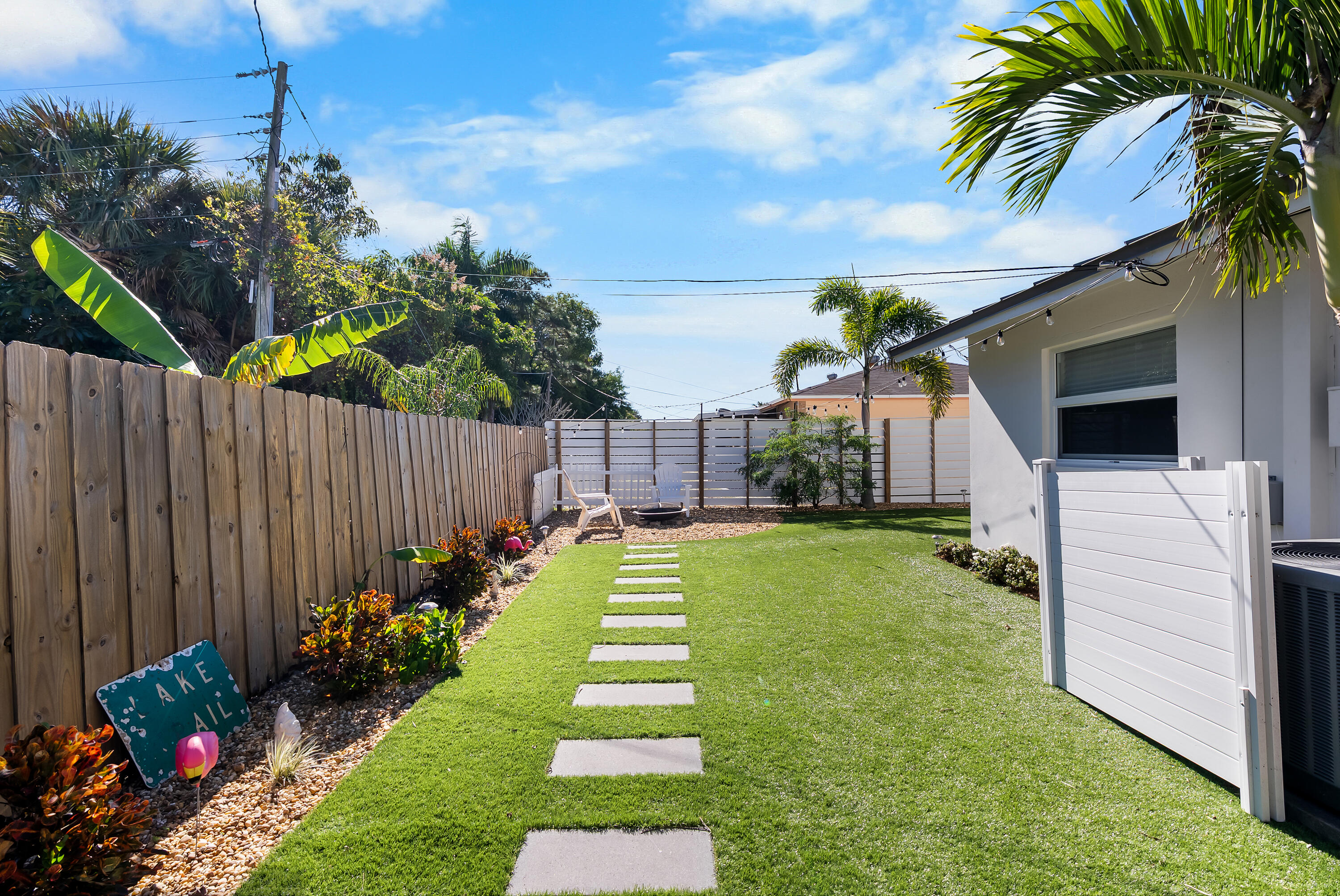 1605 Treemont Avenue Jupiter, FL 33469 - Photo 29 of 35 a view of a backyard with potted plants