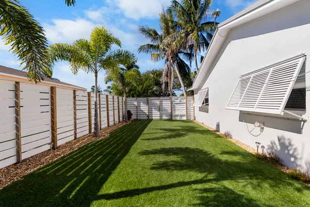 a view of a patio with table and chairs potted plants