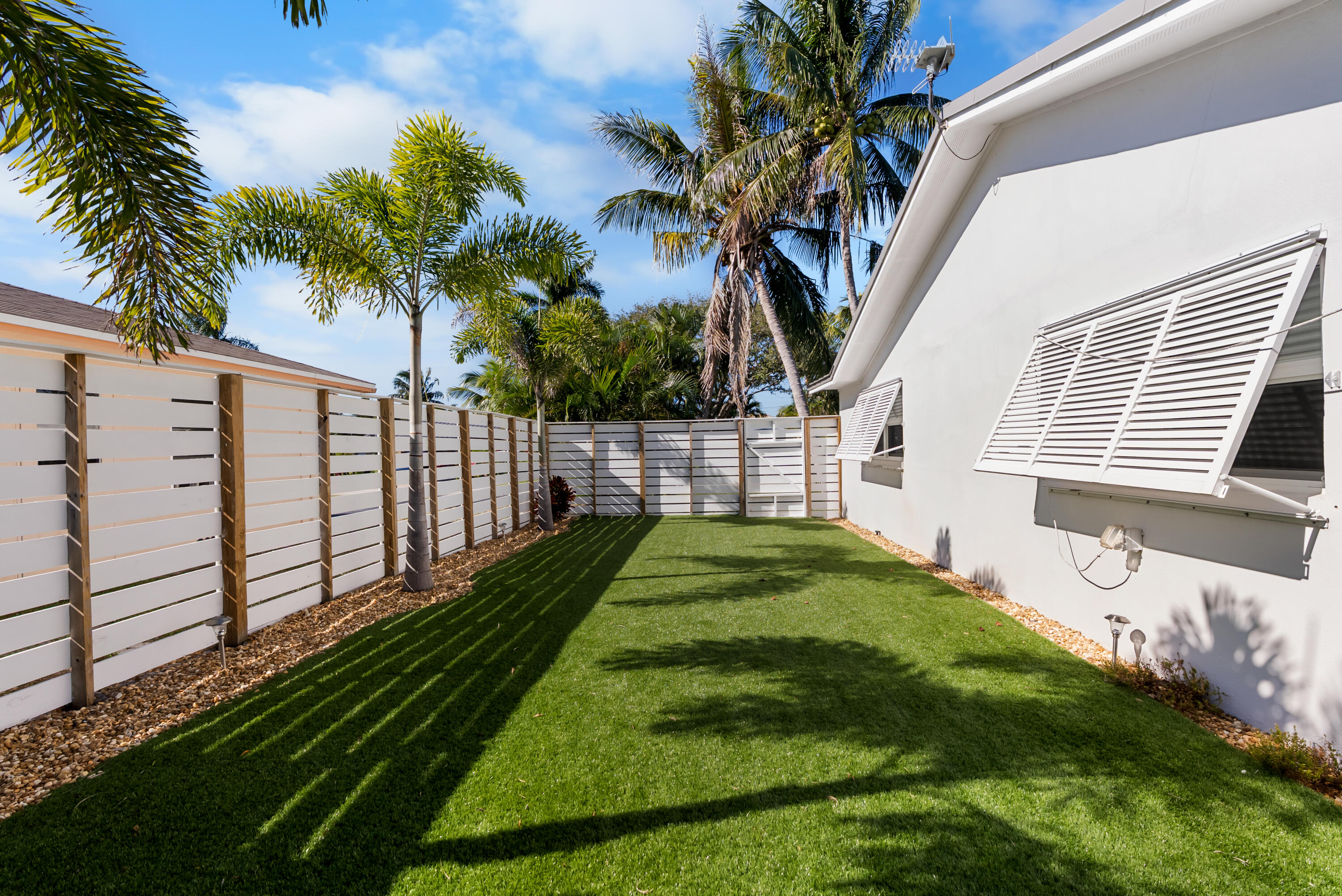 1605 Treemont Avenue Jupiter, FL 33469 - Photo 31 of 35 a view of a backyard with a garden