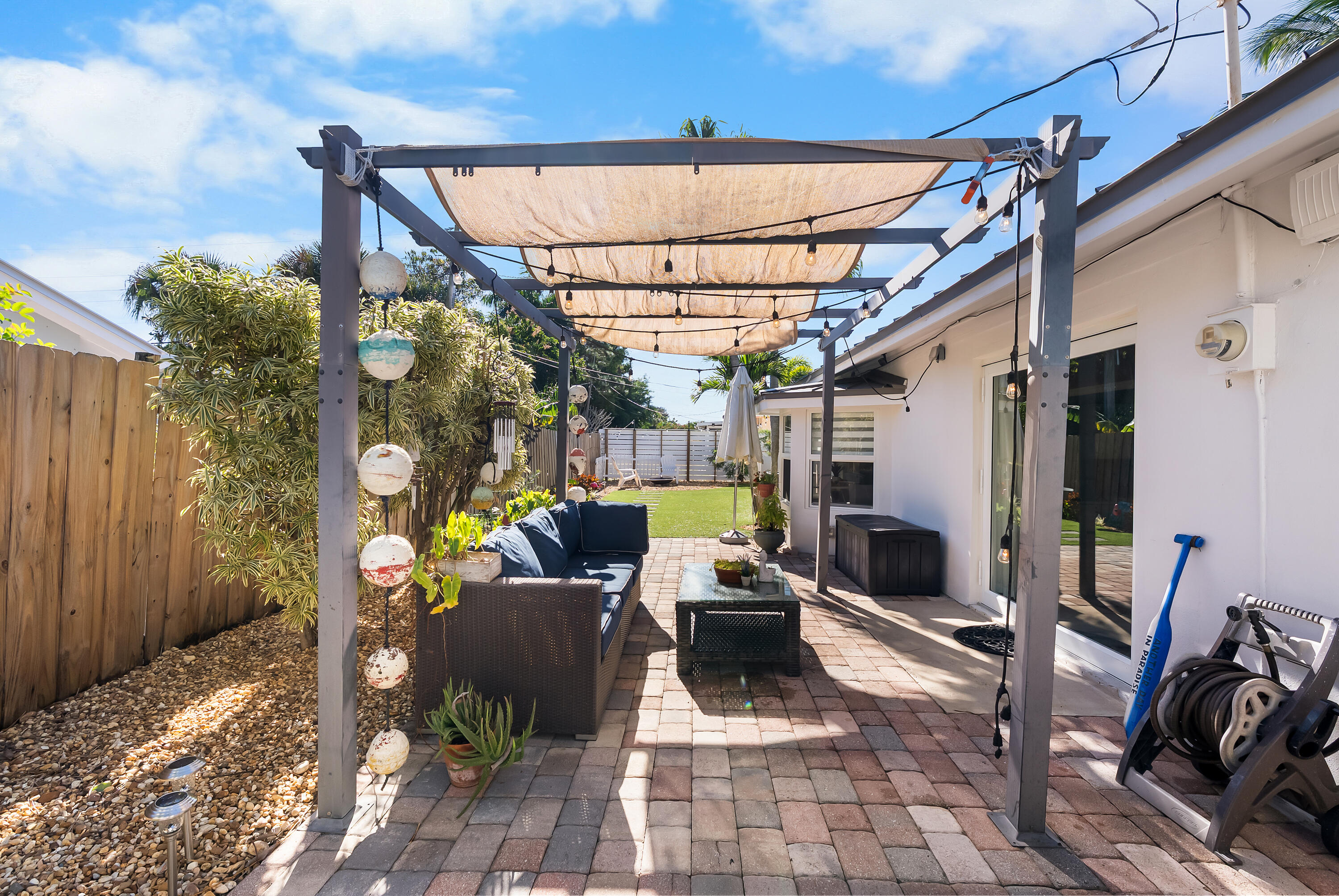 1605 Treemont Avenue Jupiter, FL 33469 - Photo 33 of 35 a view of a porch with furniture and a yard