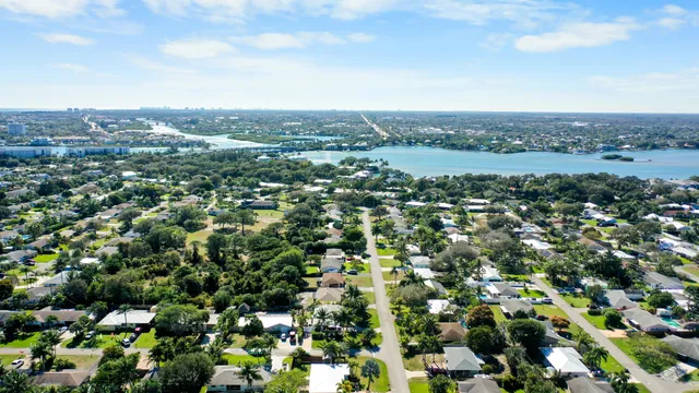 an aerial view of residential houses with city view