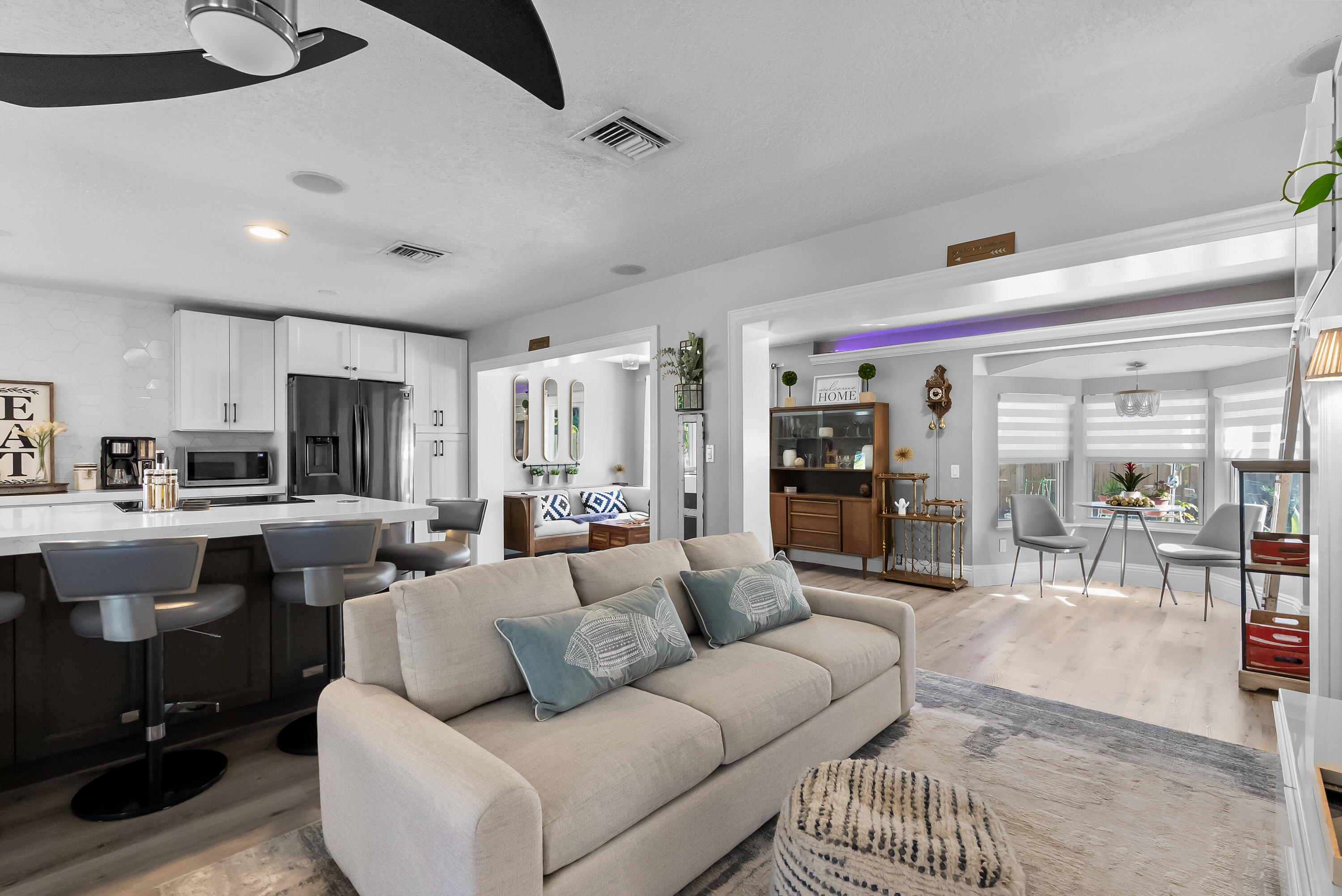 1605 Treemont Avenue Jupiter, FL 33469 - Photo 9 of 35 a living room with furniture kitchen view and a large window